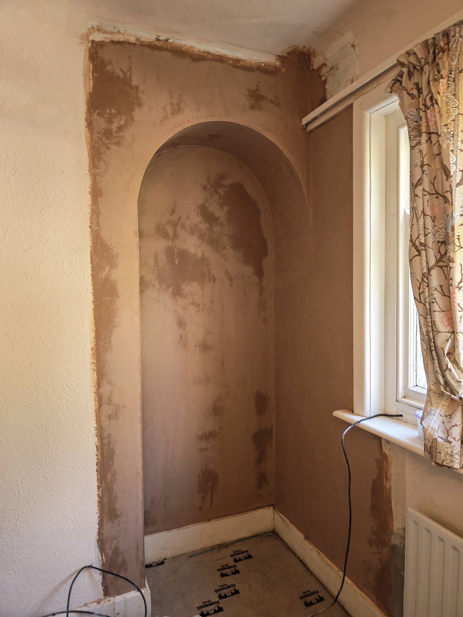 After: the same alcove patched with fresh plaster