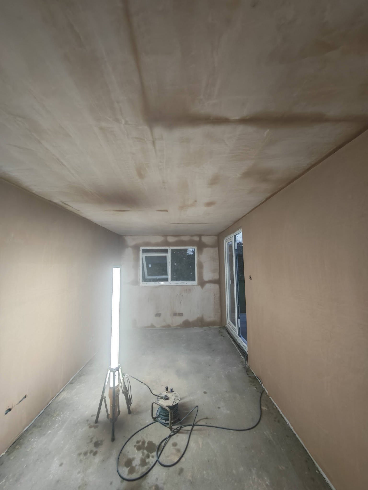 The same long room seen from the other end, fresh skim drying