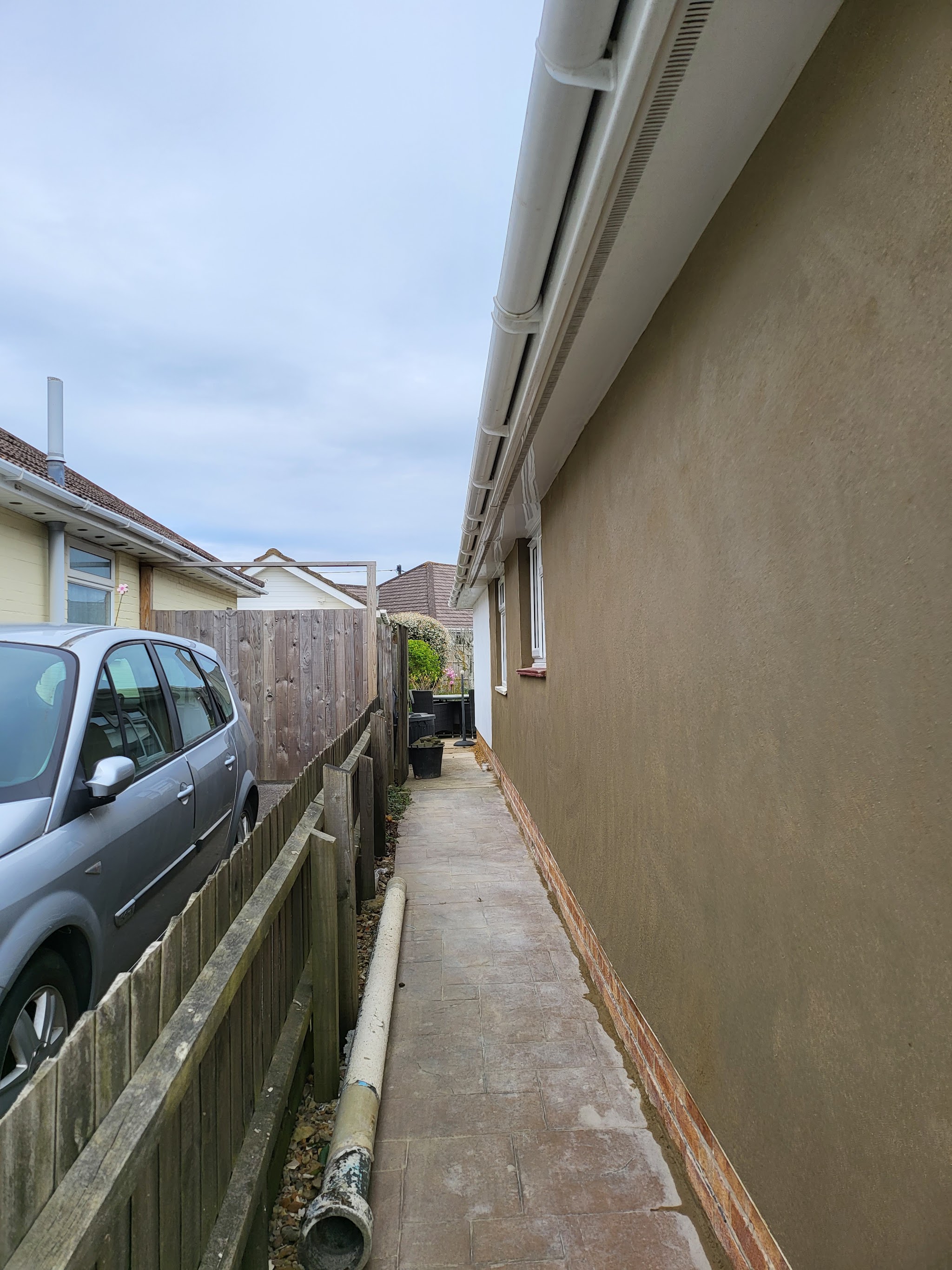Fresh render down the side wall of a bungalow